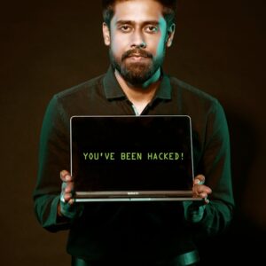 A man showing a laptop with a 'You've been hacked' message, symbolizing cyber security threats.