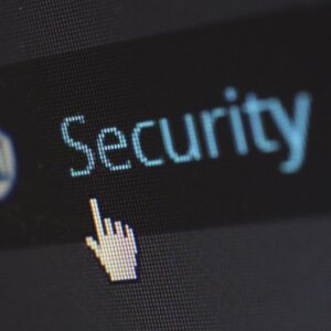 Close-up view of a mouse cursor over digital security text on display.